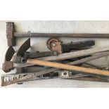 A collection of vintage wooden and metal tools.