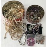2 tins of costume jewellery containing semi precious and natural stone necklaces, bracelets etc.