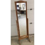 A light wood framed cheval mirror.