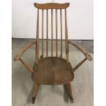 A Ercol children's blonde rocking chair.