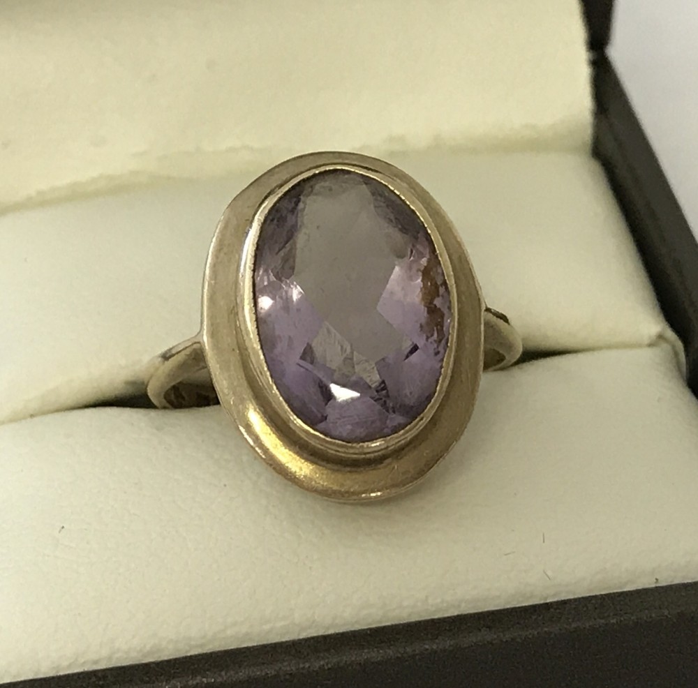 A 9ct gold bezel set amethyst dress ring.