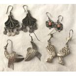 4 pairs of silver and white metal ethnic and tribal style drop earrings.