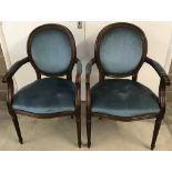 2 reproduction solid wood carver chairs with blue upholstery and fluted style legs.