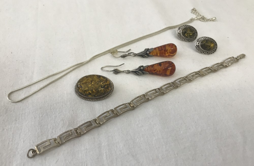 A collection of silver, amber & white metal jewellery.