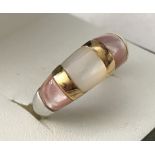 A 925 silver dome band ring set with pale pink and cream shell.