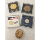 A collection of cased coins and commemorative medallions.