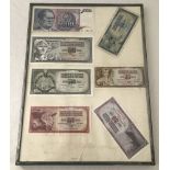 A framed collection of 7 Yugoslavian bank notes.