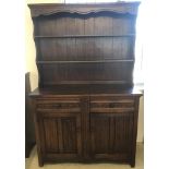 A solid dark oak Old Charm style dresser with 2 drawers and 2 cupboards to base.