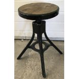 A vintage screw top metal framed stool with wooden seat.