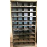 A large vintage metal industrial pigeon hole shelving unit.