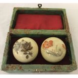 A boxed set of floral decorated oriental agate stress balls.