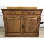 A vintage light oak Maple & Co double sideboard with carved and fluted design to sides.