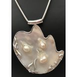 A large comtempary design blister pearl pendant set in 925 silver.