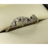 A 9ct gold and platinum 3 stone diamond art deco ring in a twist design.
