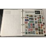 A black ring binder stamp album containing world stamps.