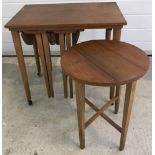 A teak wood nest of tables.