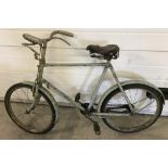 A 1950's child's bicycle with blue paintwork and original leather seat.