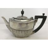 A hallmarked antique silver Bachelors teapot with half fluted design.