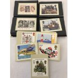 2 small albums of postcards showing British stamps together with a number of loose stamp postcards.