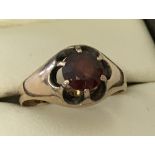 A 9ct gold central prong set garnet signet ring.