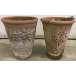 2 tall, slim terracotta garden planters with scroll decoration to sides.