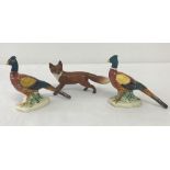 A Beswick ceramic fox figurine together with 2 Beswick pheasant figures.