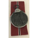 German WWII pattern Eastern Front medal with red, black and white ribbon.