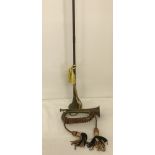 A vintage brass and copper military bugle complete with braided grip cord and tassels.