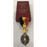 A boxed Belgian medal.