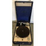 A vintage Decca portable gramophone with a small selection of 78 records.