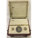 A 1957 Ferguson Flair burgundy and cream cased portable radio.