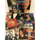 A collection of vintage vinyl LP records together with a quantity of vinyl singles.