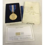 Queen Elizabeth II Golden Jubilee medal on red, white and blue ribbon.