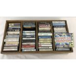 A wooden tray containing 50 vintage music tapes.
