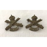 A pair of WWI pattern British Motorised Machine Gun corps collar badges.