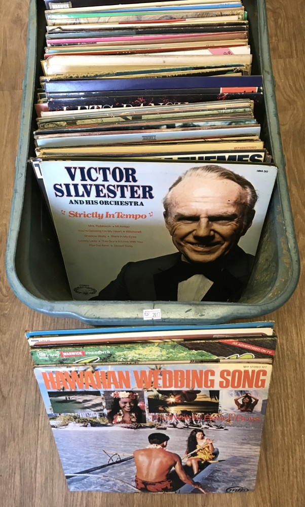 A box of assorted vintage vinyl LP records, mostly classical, musicals and world music.