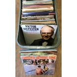 A box of assorted vintage vinyl LP records, mostly classical, musicals and world music.