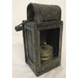 German WWII pattern train lantern with wooden handle and marked with eagle and swastika motif.