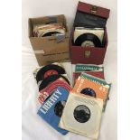 A box of late 1950's-60's vinyl 45rpm records together with a red case of 45's.