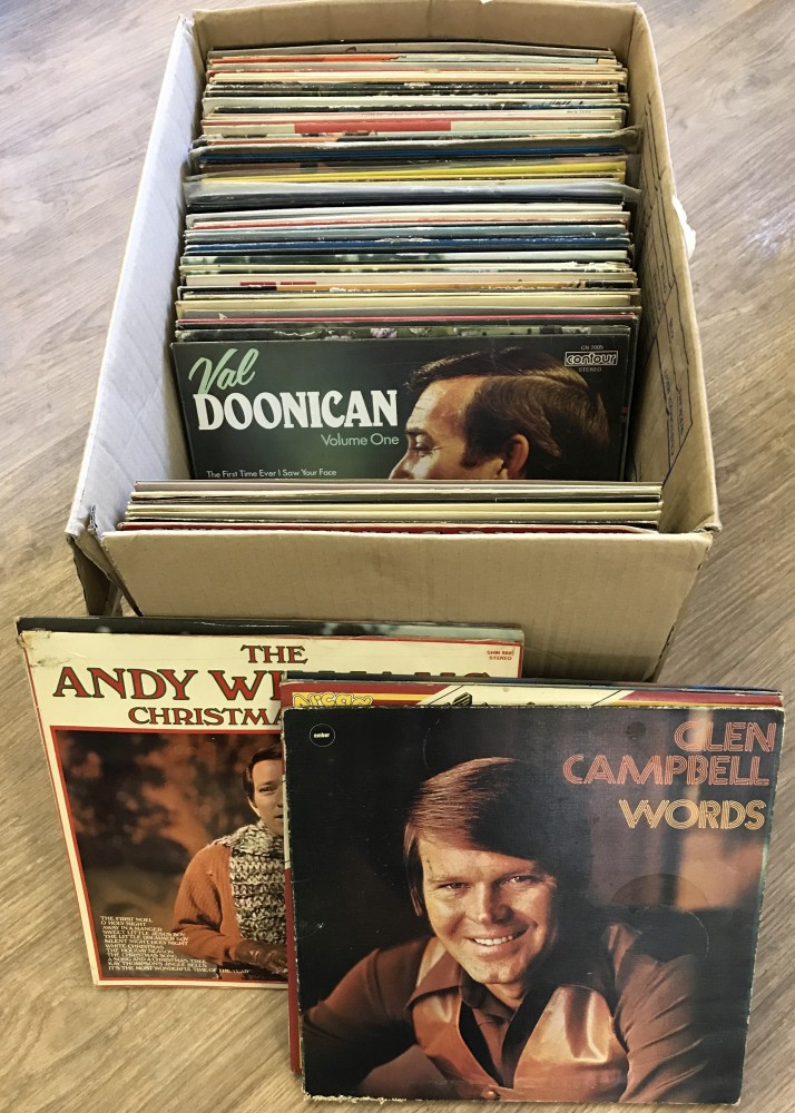 A box of assorted vintage vinyl LP records.