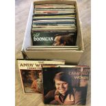 A box of assorted vintage vinyl LP records.