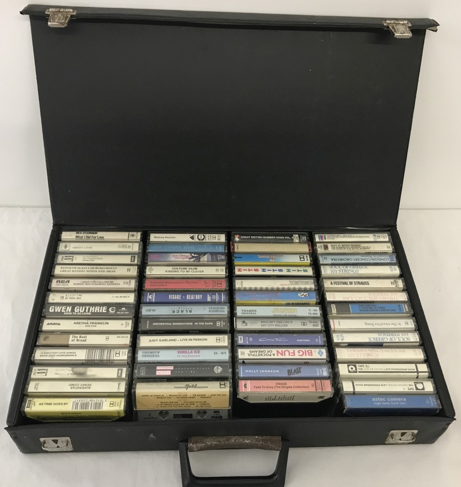 A black case containing 50 vintage music tapes.