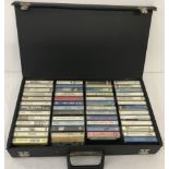 A black case containing 50 vintage music tapes.