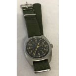 US Navy (Marines) wind up wrist watch on green canvas strap.