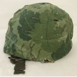 A Vietnam Era US M1 helmet with Mitch Pattern 2 season reversable cover.