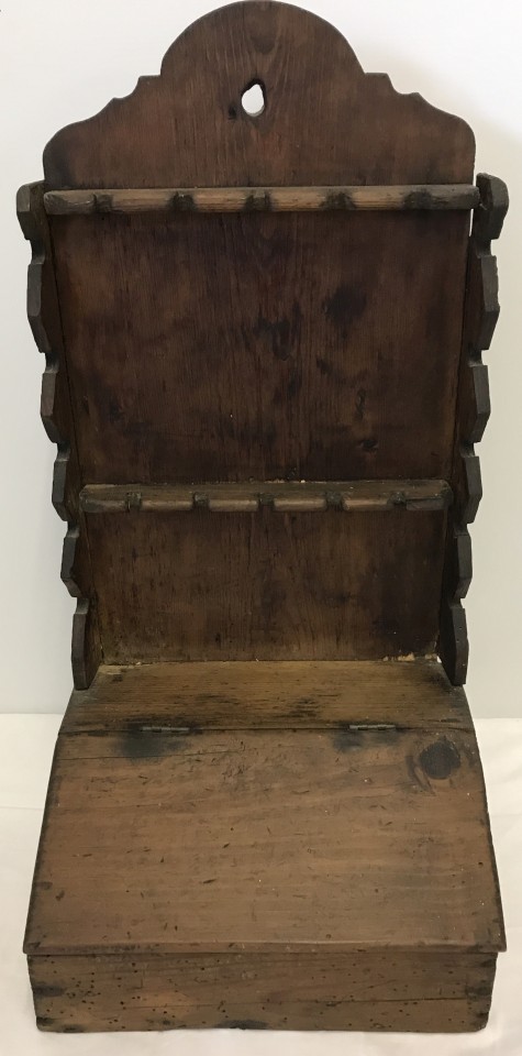 A Georgian pine spoon rack with lift up lidded cutlery box.