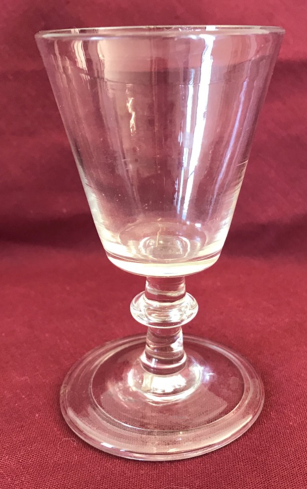 A Georgian cordial glass with knopped stem.