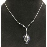 An 18ct white gold, blue & white sapphire pendant on 14ct gold chain.