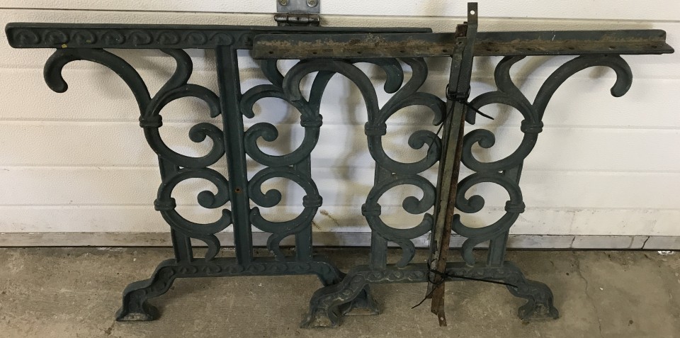 A pair of green painted cast iron scroll and floral design garden table ends.