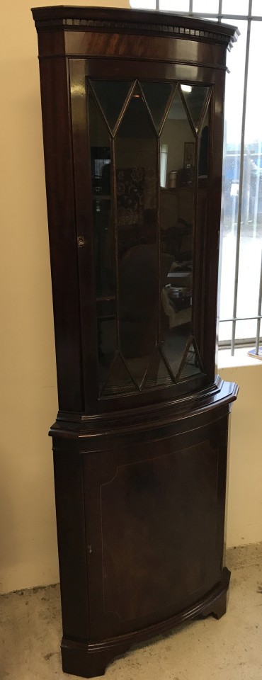 A vintage dark wood bow fronted corner unit with glazed top.